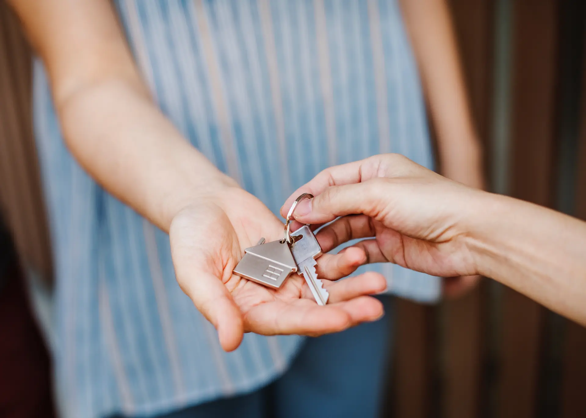 New homeowner receiving house keys at closing with real estate attorney near Deep Creek Lake Maryland